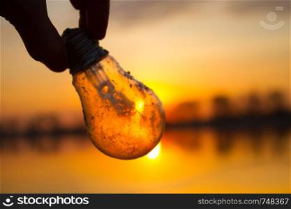 sun power concept. light bulb with sun shining through it