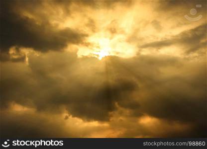 sun rays through cloudy sky, hope or opportunity concept, warm tone effect