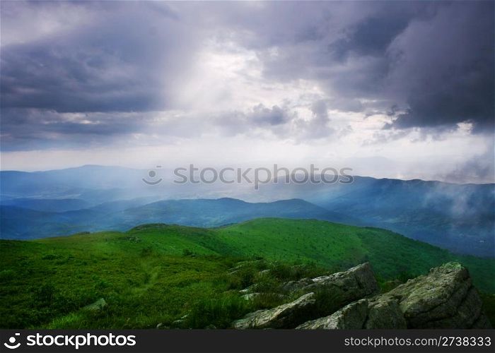 Sun rays through the cloudy sky. Carpathian Mountains