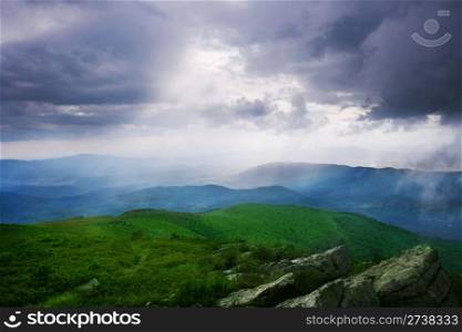 Sun rays through the cloudy sky. Carpathian Mountains