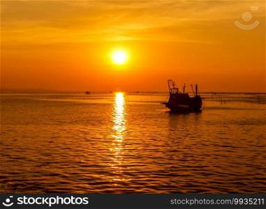 Sun reflecting Sunset the sea with fishing boats out