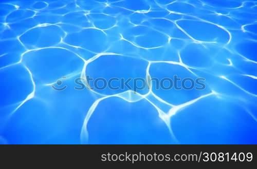 Sun reflections on a slowly moving blue water surface