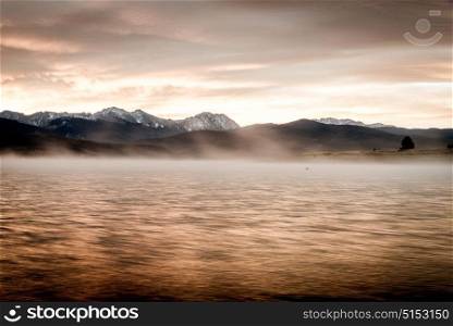 Sun rising behind Shadow Mountain, Colorado with Grand Lake in the foreground