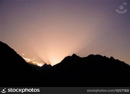 Sun rising behind the mountains. Gilgit-Baltistan, Pakistan.