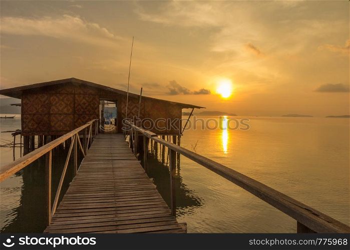 Sun rising over house on stilts, Phang Nga Bay, Phuket, Thailand