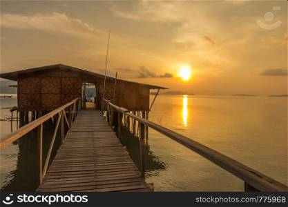 Sun rising over house on stilts, Phang Nga Bay, Phuket, Thailand