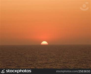 Sun setting on the horizon at Mediteranean Sea