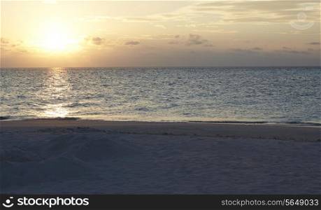 Sun Setting Over Beautiful Deserted Beach