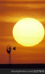 Sun Setting Over Windmill