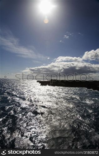 Sun shining on coastline with Pacific ocean on Maui, Hawaii.
