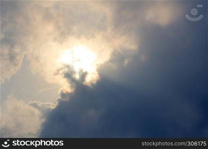 Sun shining through dark clouds