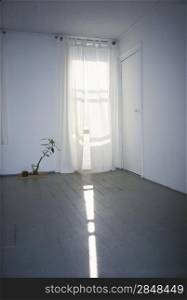 Sun shining through the curtain in an empty room