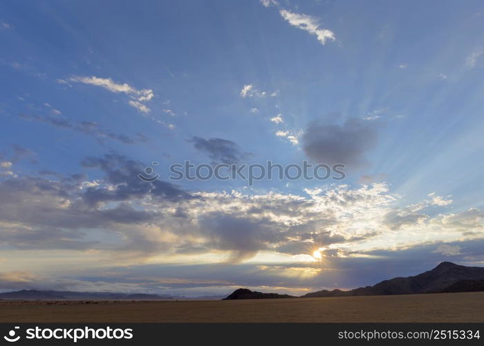 Sun starburst through the clouds Namib Desert Namibia