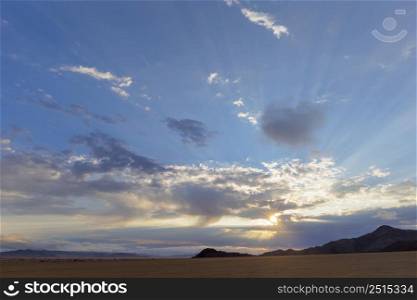 Sun starburst through the clouds Namib Desert Namibia