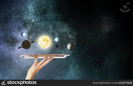 Sun system planets. Close up of hand holding tray with sun system planets