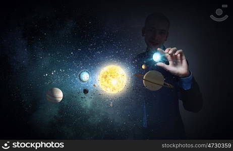 Sun system. Young businessman taking with fingers planet of sun system