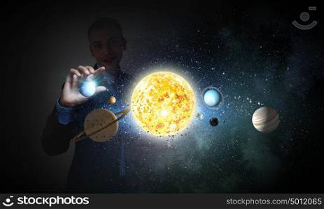 Sun system. Young businessman taking with fingers planet of sun system