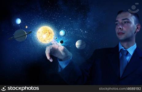 Sun system. Young businessman touching with finger planet of sun system