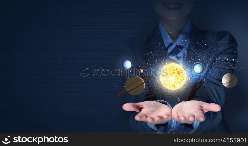 Sun system. Young businesswoman holding in palm planet of sun system