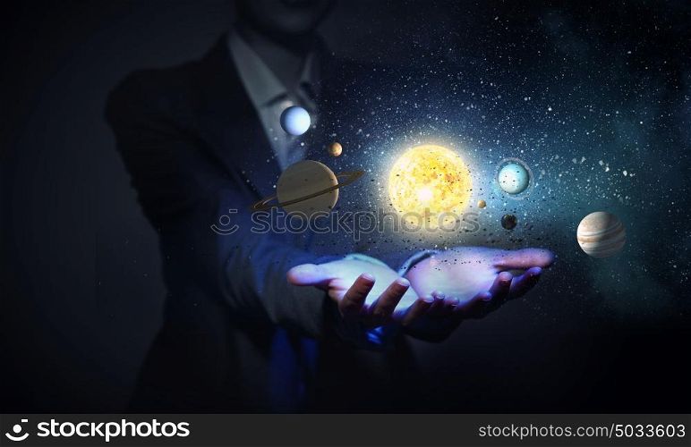 Sun system. Young businesswoman holding in palm planet of sun system