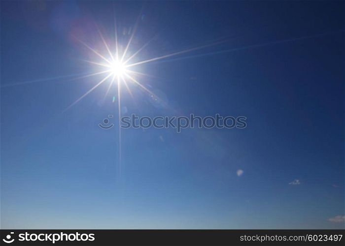 Sun with lens flare. Sun with lens flare in clear blue sky