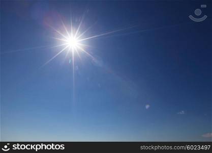 Sun with lens flare. Sun with lens flare in clear blue sky