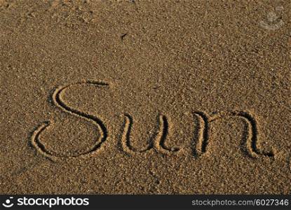 sun word on the sandy beach. Travel concept