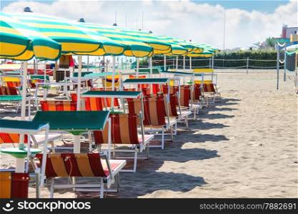 Sunbeds and umbrellas on the beach in the resort town Bellaria Igea Marina, Rimini, Italy
