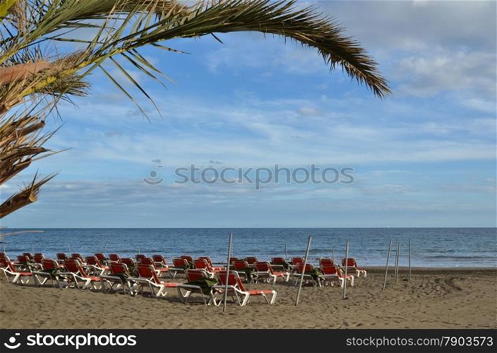 Sunbeds at the beach by the resort San Augustin, Gran Canaria, Canary Islands, Spain