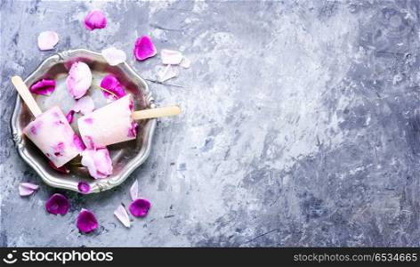 Sundae with taste of rose. Summer vanilla ice cream with fresh rose flowers