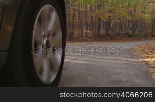 Sunday drive on country road in autumn spinning front wheel PoV