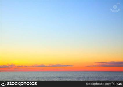 Sundown over Baltic Sea - beautiful seascape with sea horizon and colorful sky and clouds. Copyspace composition