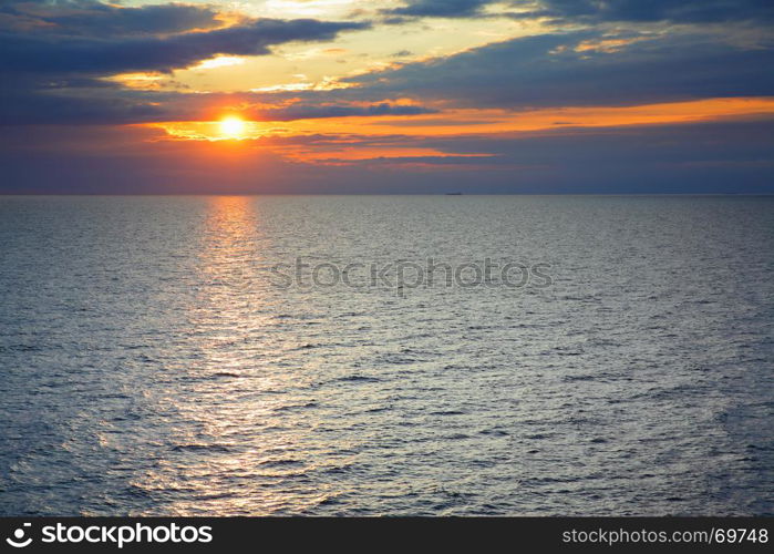 Sundown over Baltic Sea - scenic sunset seascape with sea horizon and colorful clouds. Copyspace composition