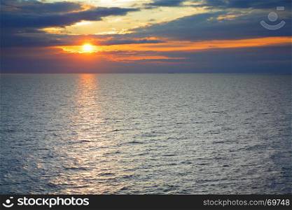 Sundown over Baltic Sea - scenic sunset seascape with sea horizon and colorful clouds. Copyspace composition