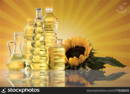 Sunflower oil, olive oil on sunburst orange background
