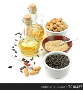 Sunflower seeds, peanuts and oil isolated on a white background