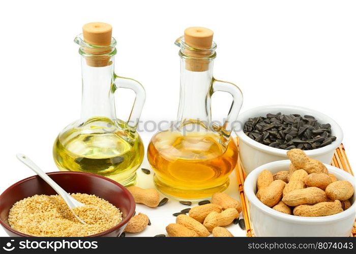 Sunflower seeds, peanuts and oil isolated on white