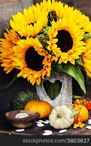 Sunflowers and Autumn decorations on wooden background