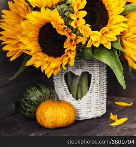 Sunflowers and Autumn decorations on wooden background