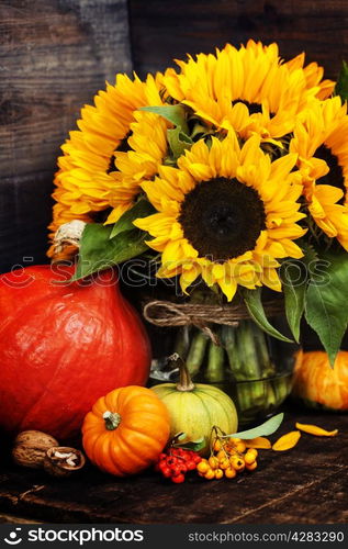 Sunflowers and Autumn decorations on wooden background