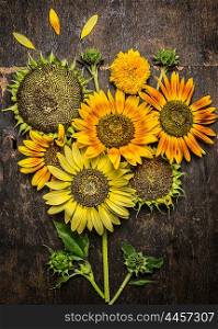 Sunflowers composing on rustic wooden background, top view