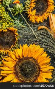 Sunflowers on dark vintage background, top view, close up