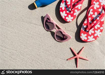 Sunglasses and flip flop on white sandy tropical beach, Summer vacation and travel concept