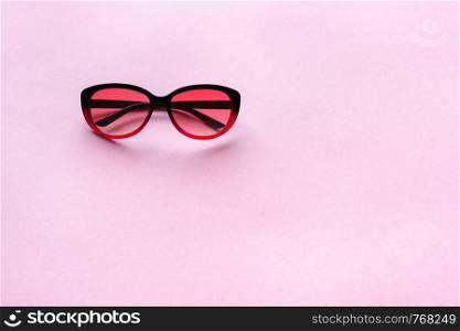 Sunglasses on pink pastel background. Concept summer, trend, copy space
