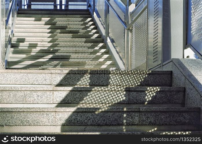 Sunlight and shadow on empty marble stairs of footbridge, architecture concept