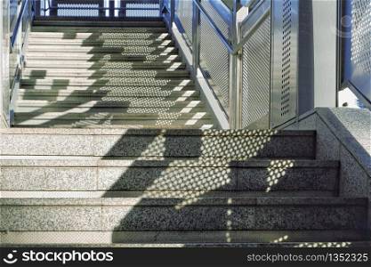Sunlight and shadow on empty marble stairs of footbridge, architecture concept