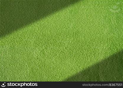 Sunlight and shadow on surface of vintage green concrete wall background with roughness and detail grain