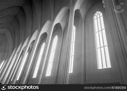 Sunlight coming through tall windows in a church