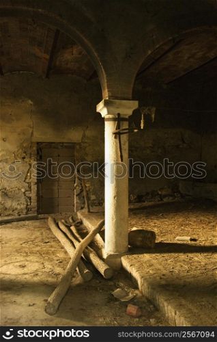 Sunlight filling old abandoned building with column and arches in Tuscany, Italy.