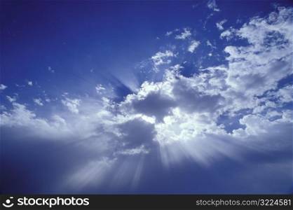 Sunlight Filtered Through Clouds In A Blue Sky